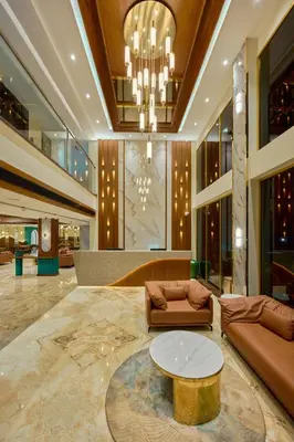 a lobby with a couch and a table at Kowju Airport Hotel Calicut in Kondotti
