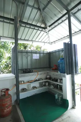 a garage with a green floor in the middle at Ganga Homes Rooms Only in Trichūr