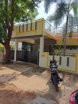 a motorcycle parked in front of a house at S R Luxurious Fully Ac 3 BHK Bunglow Mysore in Mysore