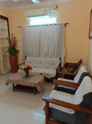 a living room with a couch and tables and a window at S R Luxurious Fully Ac 3 BHK Bunglow Mysore in Mysore