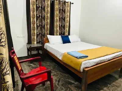 a bedroom with a bed and a red chair at Montage Villa in Kozhikode