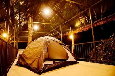a tent sitting inside of a building with lights at BLUE CREEK resort in Meppādi