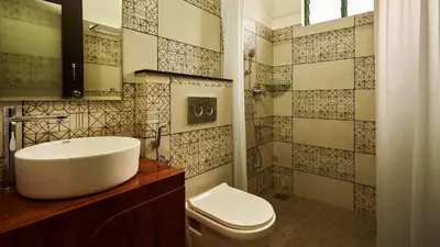 a bathroom with a sink and a toilet at Silvertrails in Kalpetta