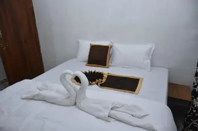 two swans made out of towels on a bed at Dream inn family homestay in Meenangadi