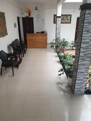 a waiting room with chairs and a reception desk at Spectrum stays in Ambalavayal