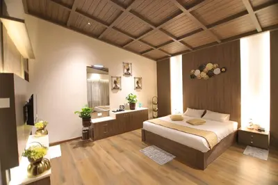 a bedroom with a large bed and a bathroom at Cataleya in Kotagiri