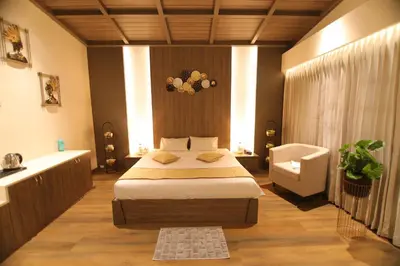 a bedroom with a bed and a chair in it at Cataleya in Kotagiri