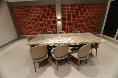 a dining room with a marble table and chairs at CATALEYA Home Stay in Kotagiri