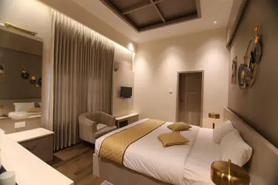 a hotel room with a bed and a bathroom at CATALEYA Home Stay in Kotagiri