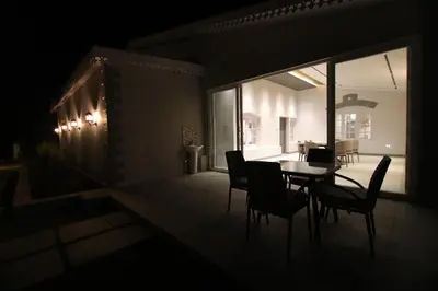 a dark room with a table and chairs on a patio at CATALEYA Home Stay in Kotagiri