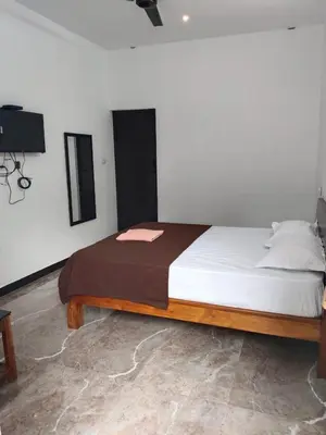 a bedroom with a large bed in a room at Dream Nest Resort in Mettuppālaiyam