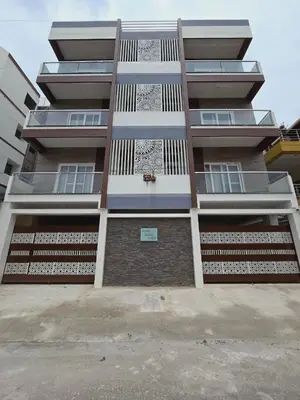 a tall apartment building with a lot of windows at Nandan Enclave in Mysore