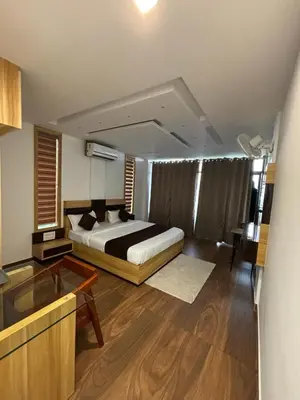 a bedroom with a bed and a television in it at Lush Hills by Benchmark in Kalpetta