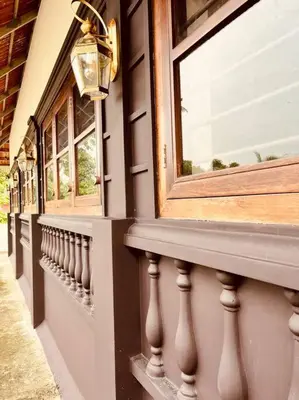 a building with a balcony with windows and a street at Haven Stay Manor in Kotamangalam