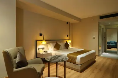 a bedroom with a bed and a chair and a table at mesta Hotel in Sultan Bathery