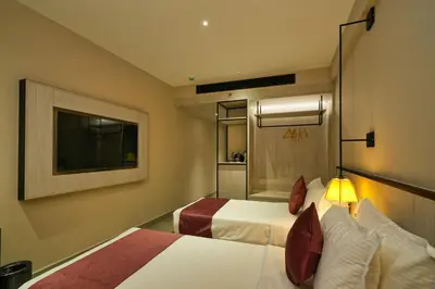 a hotel room with two beds and a television at mesta Hotel in Sultan Bathery