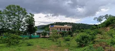 a house on the side of a hill at Sathyam Resorts in Dharmapuri