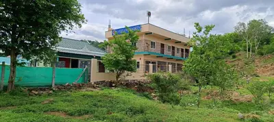 a house on the side of a hill at Sathyam Resorts in Dharmapuri
