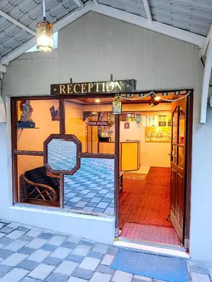 an open door to a restaurant with a sign on it at BN Tourist Home in Ooty