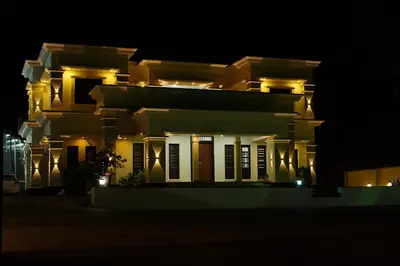 a large building at night with its lights on at Hill Club Square in Malappuram