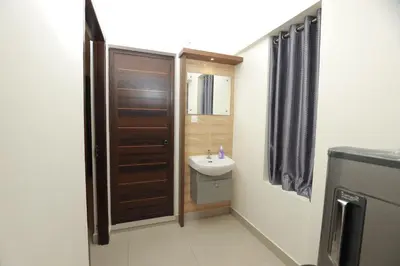 a small bathroom with a sink and a toilet at VVP Service Apartments & Airport Suits in Cochin