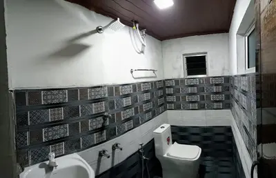 a bathroom with a sink and a toilet at RIVERVIEW HOMESTAy in Vālpārai