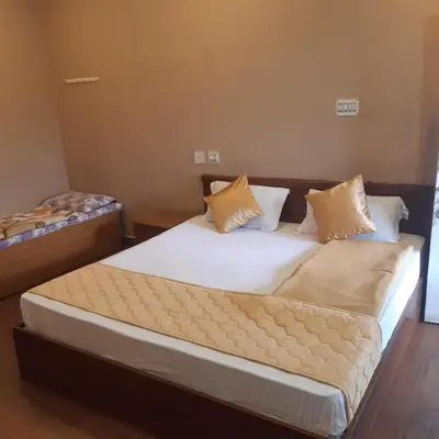 a bedroom with two beds with white sheets and pillows at RIVERVIEW HOMESTAy in Vālpārai