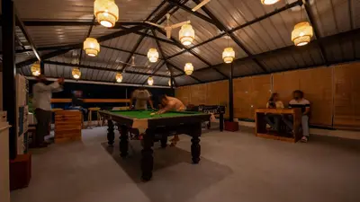 a room with a pool table in it with people at Trippr Mysuru in Mysore