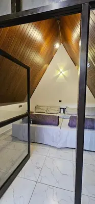a large room with two beds in a room at The Soul Of Vattavada in Vattavada