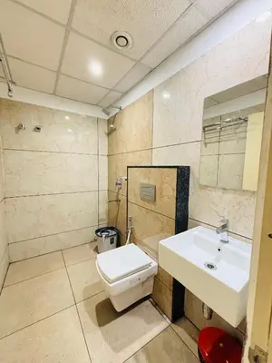 a bathroom with a sink and a toilet at Hotel Starfinch Inn in Kushālnagar