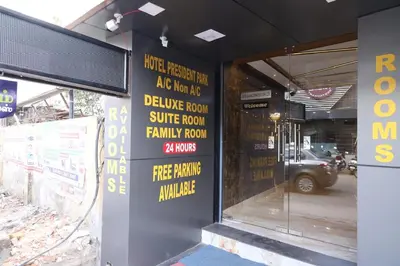 a store front with signs on the side of a building at Hotel president park Coimbatore in Coimbatore