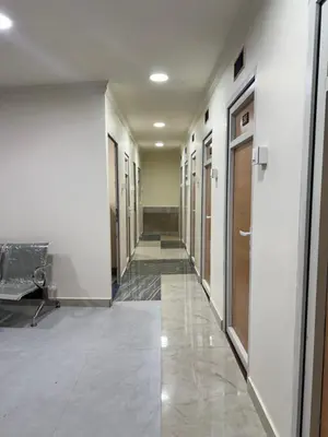 a hallway with a row of doors in a building at Hotel president park Coimbatore in Coimbatore