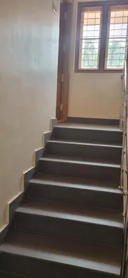 a set of stairs in a building with a window at Agraharam Hindu Home stay - Advaitham in Palakkad