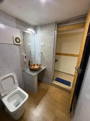 a bathroom with a toilet and a walk in shower at Rozana Retreats Ooty in Ooty