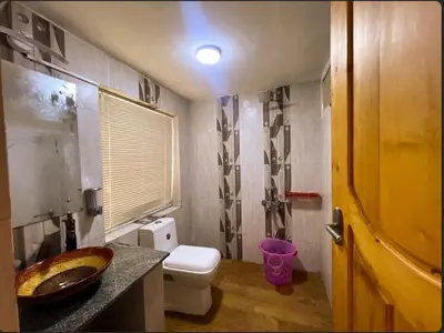 a bathroom with a sink and a toilet in it at Rozana Retreats Ooty in Ooty