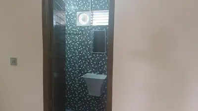 a bathroom with a toilet in a shower at SHI's Thulasi 2BHK in Coimbatore Near to Karpagam College, Palakkad Highway, Rathinam College and More in Coimbatore