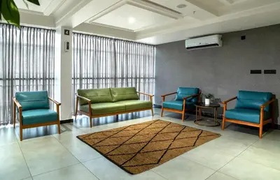 a waiting room with two chairs and a rug at ESPERO INN Malappuram in Malappuram