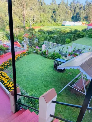 a view of a garden from a balcony at Rosewood 1 in Ooty