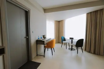 a room with chairs and a table and a window at Mount Land in Sultan Bathery