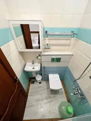 a small bathroom with a sink and a toilet at Welcome Hotels in Trichūr