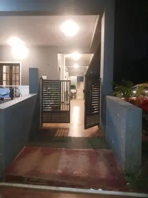 a stairway leading to a house at night at Coorg Sunway home stay in Madikeri