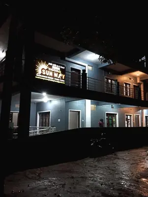 a building with a sign on it at night at Coorg Sunway home stay in Madikeri
