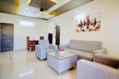 a living room with a couch and a table at Elite Enclave - Tellus - 2BHK - Luxury Serviced Apartments in Mysore