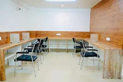 a conference room with chairs and a wooden wall at Elite Enclave - Tellus - 2BHK - Luxury Serviced Apartments in Mysore