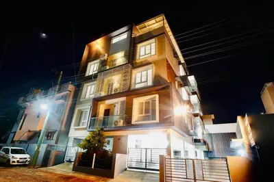 a building with a car parked in front of it at Elite Enclave - Tellus - 2BHK - Luxury Serviced Apartments in Mysore