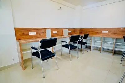 a room with a bar with black chairs in it at Elite Enclave - Tellus - 2BHK - Luxury Serviced Apartments in Mysore
