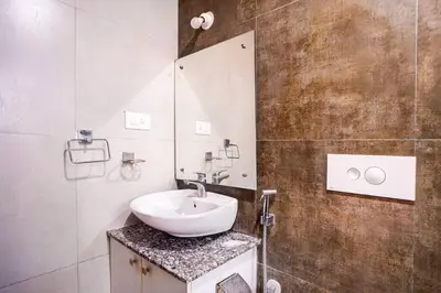 a bathroom with a sink and a mirror at Elite Enclave - Spark - 2BHK Luxury Serviced Apartment in Mysore