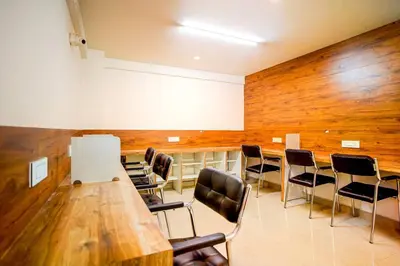 a conference room with a long table and chairs at Elite Enclave - Vento - 2BHK Luxury Serviced Apartments in Mysore