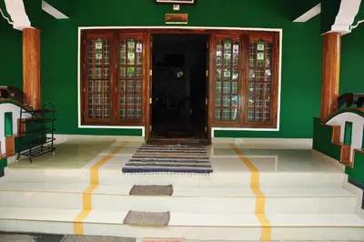 a room with a green wall and a door at County Pep in Wayanad
