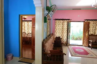 a living room with pink and blue walls at County Pep in Wayanad
